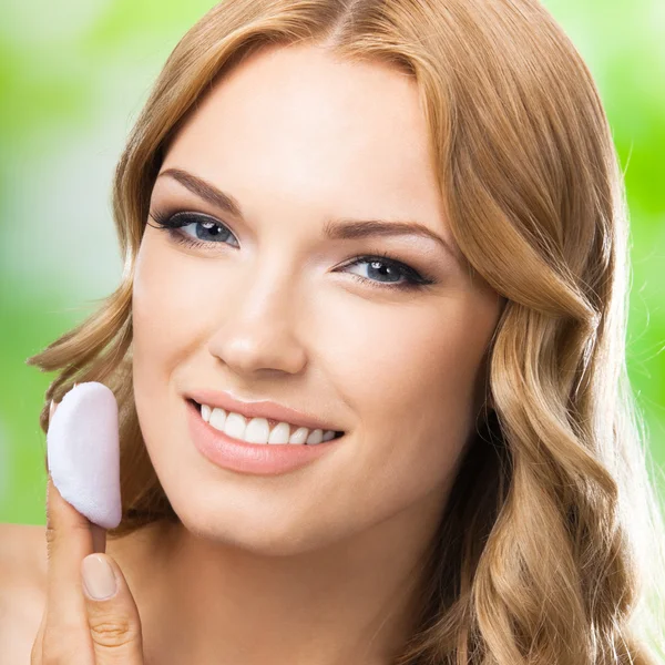 Blond woman cleaning skin by cotton pad, outdoor — Stock fotografie