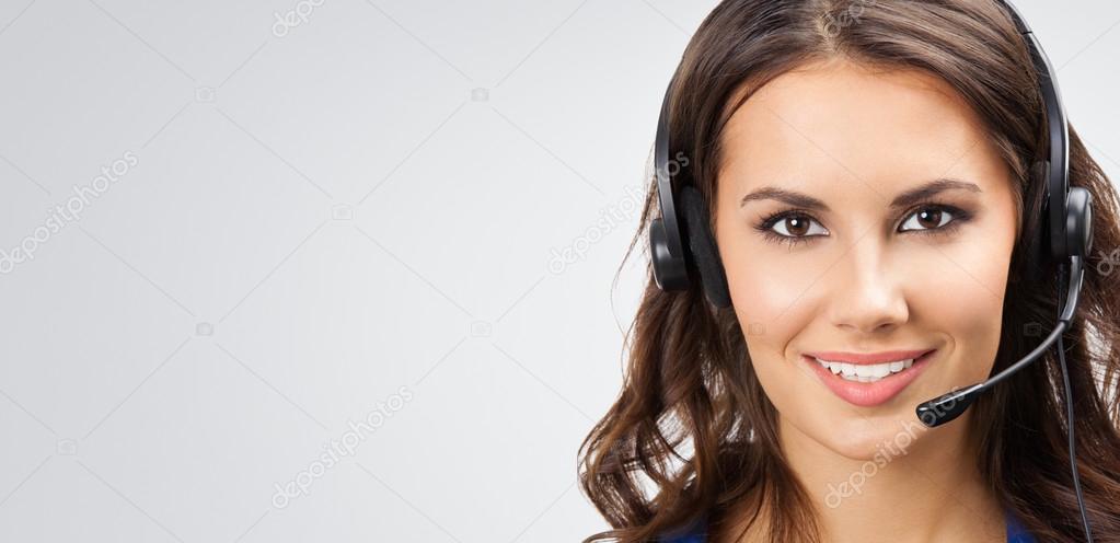 smiling young support phone operator, with copyspace, on grey  