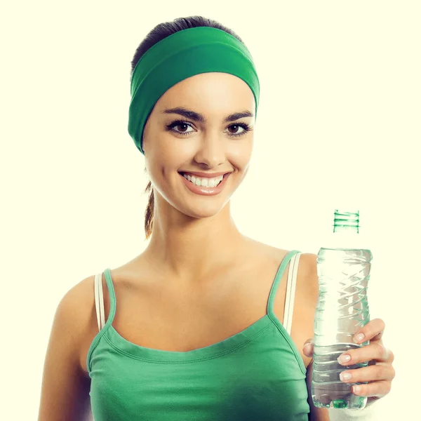 Cheerful young woman in green fitness wear with water — Stock Photo, Image