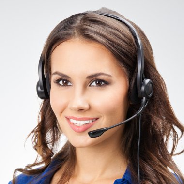 smiling young female support phone operator, with copyspace, on 