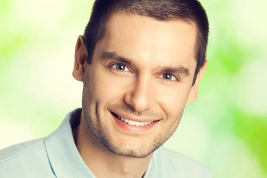 young happy smiling handsome brunette man, outdoors