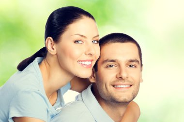 young happy smiling embracing lovely couple, outdoors