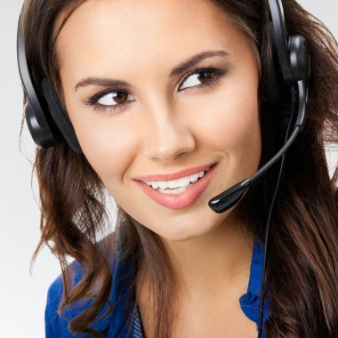smiling young support phone operator, on grey  