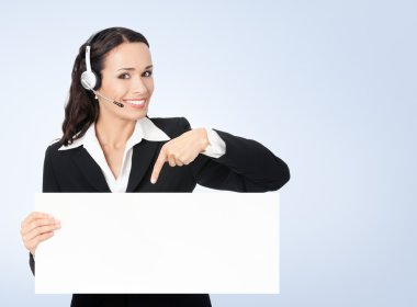 young happy female support phone operator pointing on signboard