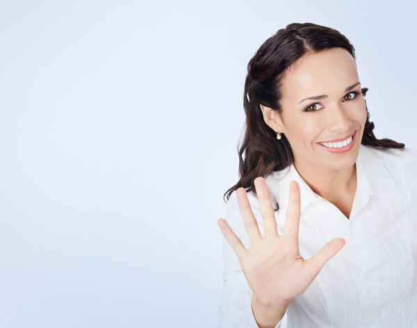 Businesswoman showing five fingers