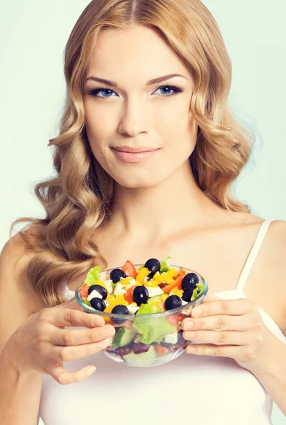 Lovely woman with vegetarian salad, over blue — Stock Photo, Image