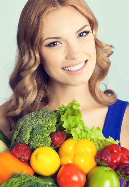 Lovely woman with vegetarian food, on blue — Zdjęcie stockowe