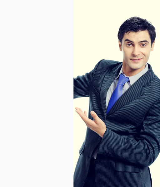 Cheerful businessman showing blank signboard — Stock Photo, Image