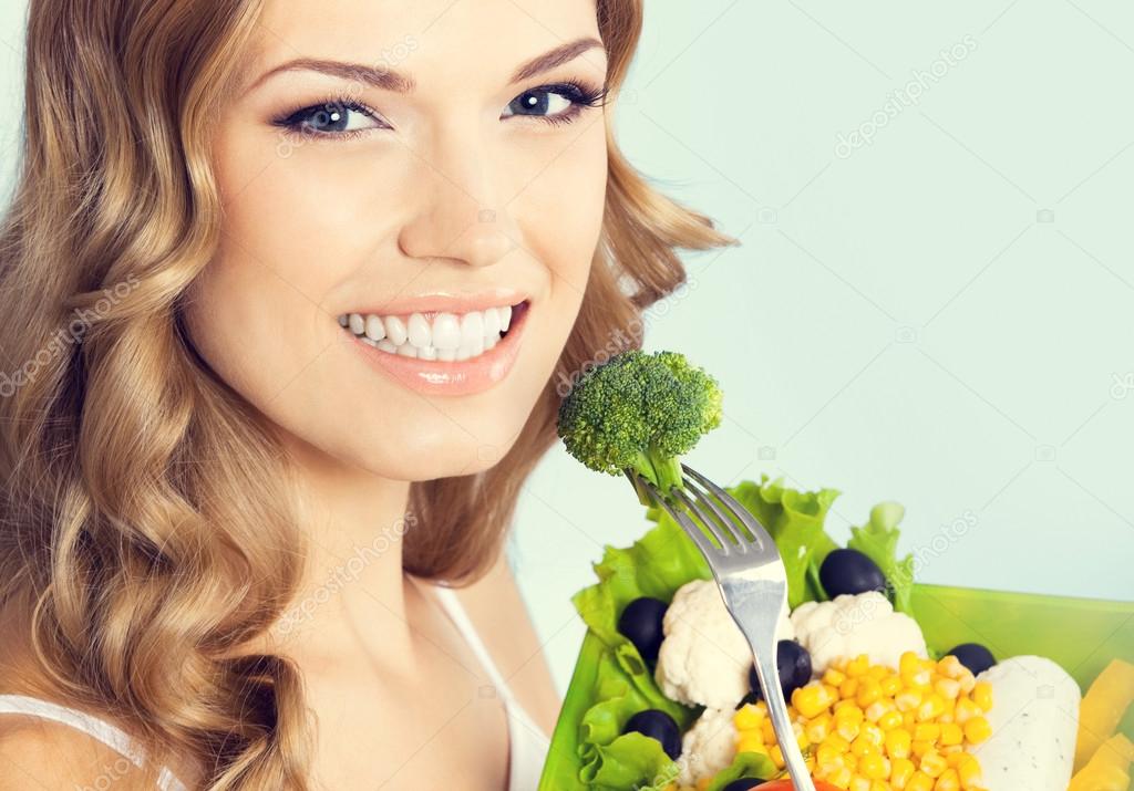 lovely woman with vegetarian salad, over blue