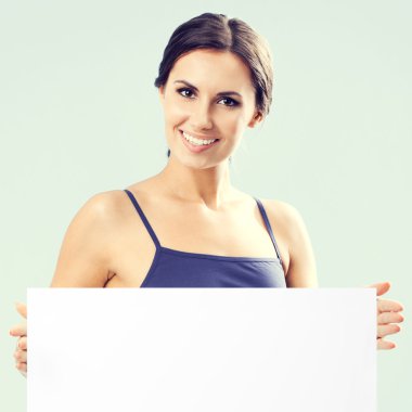 young smiling woman in fitnesswear showing signboard clipart
