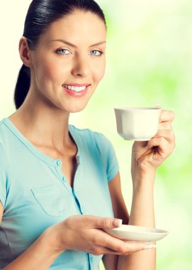 smiling lovely woman drinking coffee, outdoor