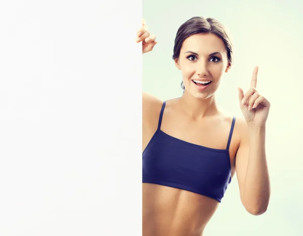 Mujer feliz en ropa de fitnesswear mostrando letrero — Foto de Stock