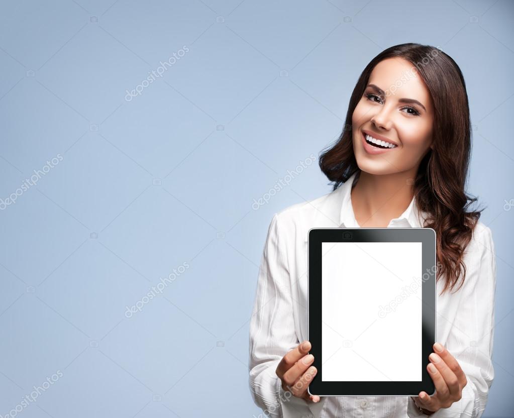 Businesswoman showing blank tablet pc, with copyspace