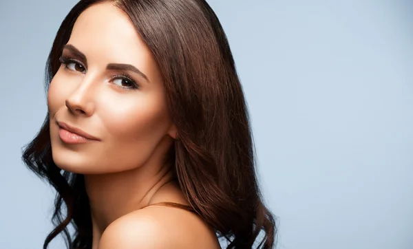 Portrait of beautiful young woman with naked shoulders, on grey — Stock Photo, Image