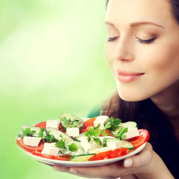 Young lovely woman with plate of salad Royalty Free Stock Images