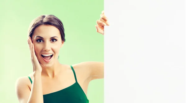Kvinna i fitnesswear visar skylt, på grön — Stockfoto