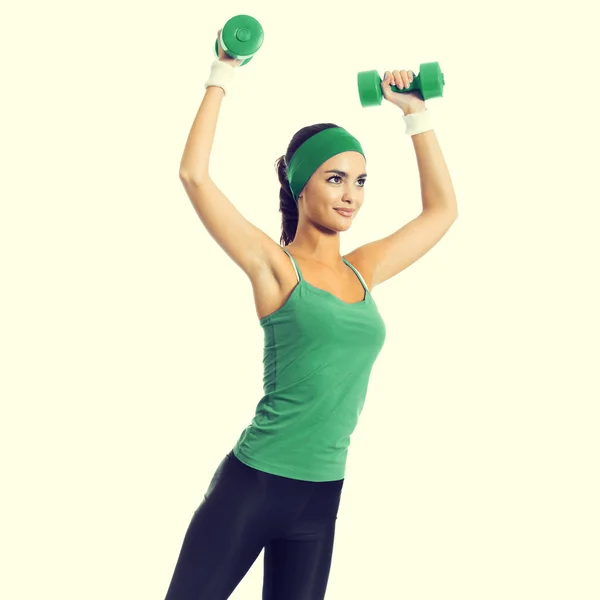 Young brunette woman exercising with dumbbells — Stockfoto