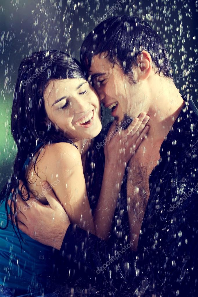 Young couple hugging and under a rain, in passion - Stock Photo, Image. 