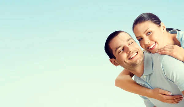 Cheerful young couple, over blue — Stock Photo, Image