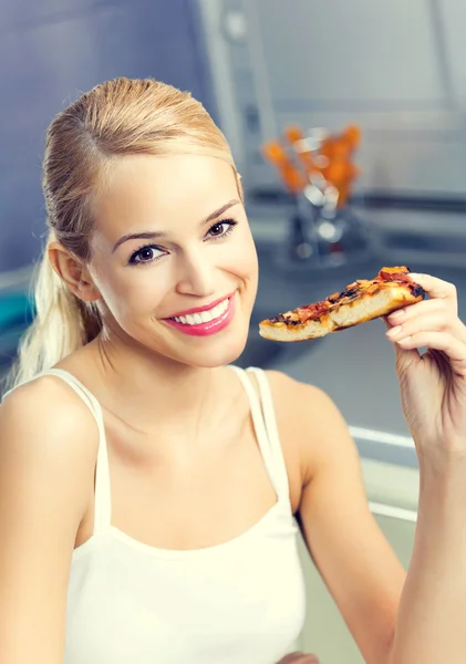 Young happy woman with pizza, indoors Royalty Free Stock Photos