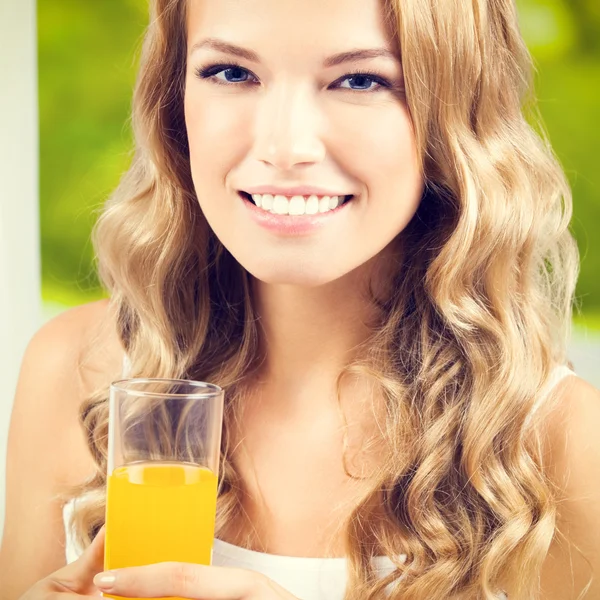 Happy woman drinking juice — Stock Photo, Image