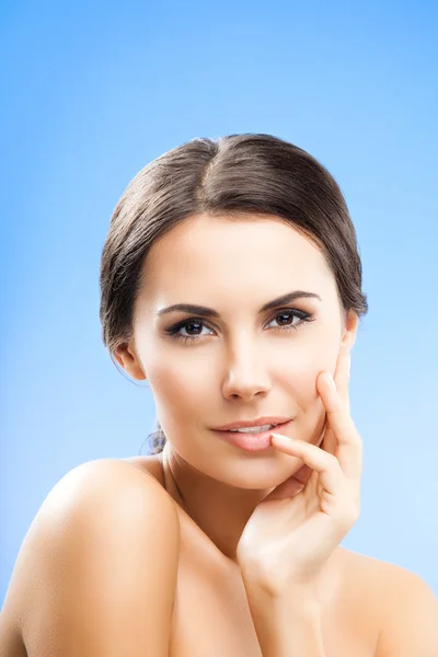 Portrait of woman with naked shoulders, on blue — Stock Photo, Image