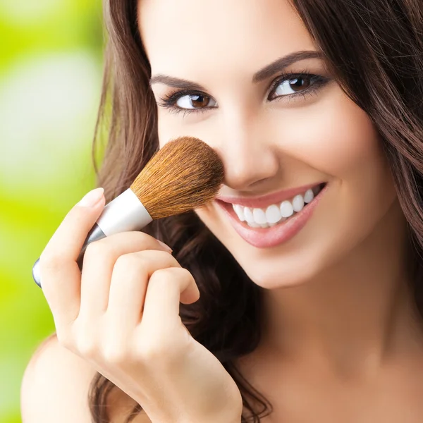 Young woman with make up brush — Stock Photo, Image