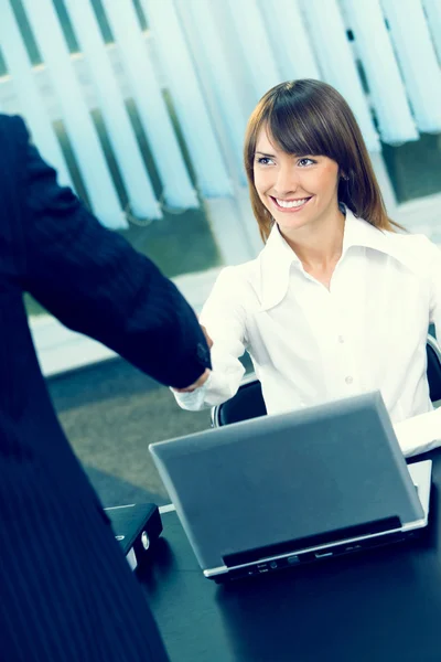 Two businesspeople cheering by handshake at office — Stock Photo, Image