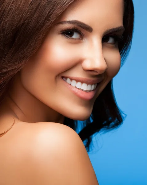 Beautiful smiling woman, on blue — Stock Photo, Image