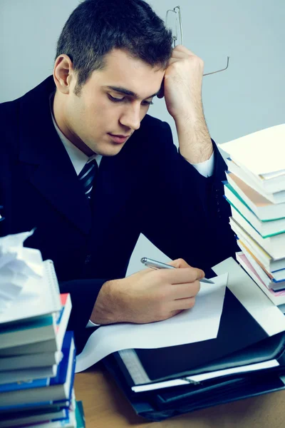 Young student or businessman writing something on blank paper sh — Stock Photo, Image