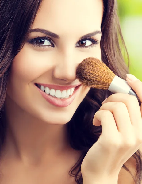 Young woman with make up brush — Stock Photo, Image