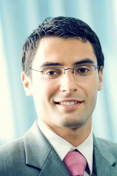 Portrait of happy smiling businessman at office — Stock Photo, Image