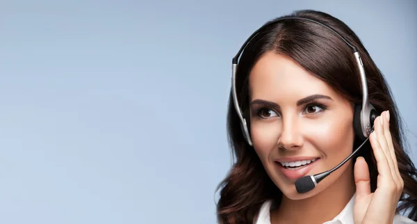 Portrait of cheerful customer support female phone operator in h — Stock Photo, Image