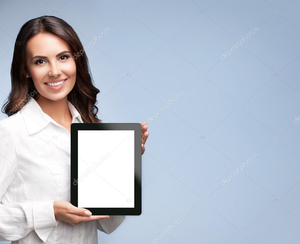 Business woman showing blank tablet pc, on grey 