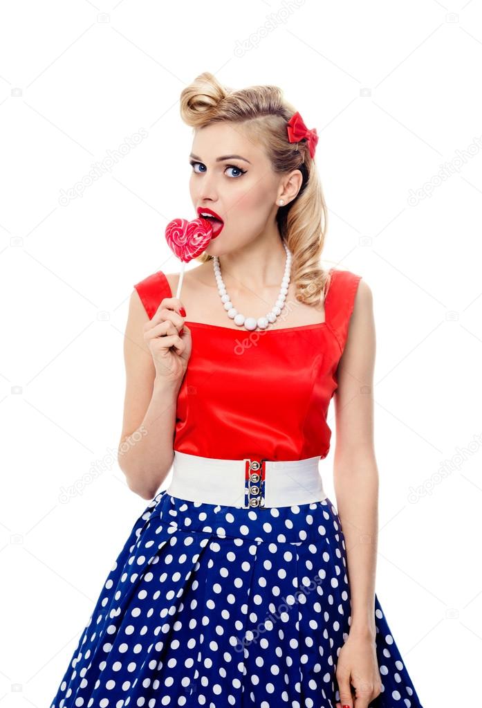 young woman eating colourful lollipop, dressed in pin-up style