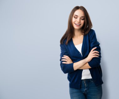 smiling young woman with crossed arms, with copyspace