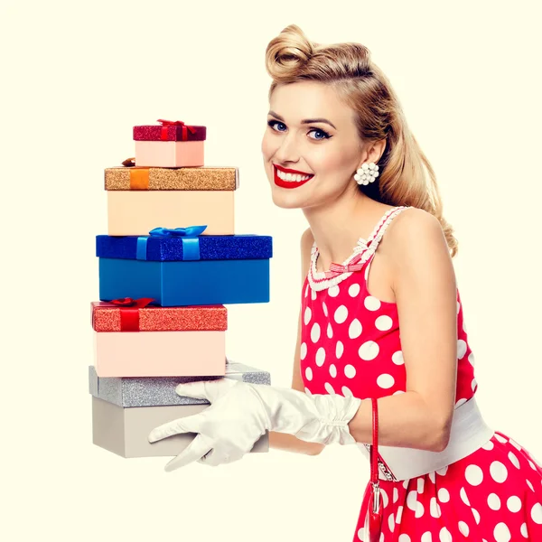 Woman in pin-up style red dress with gift boxes — 스톡 사진