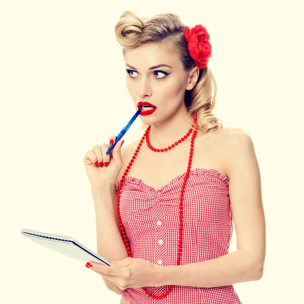 Smiling woman with notepad, in pin-up style clothing — Stock Photo, Image