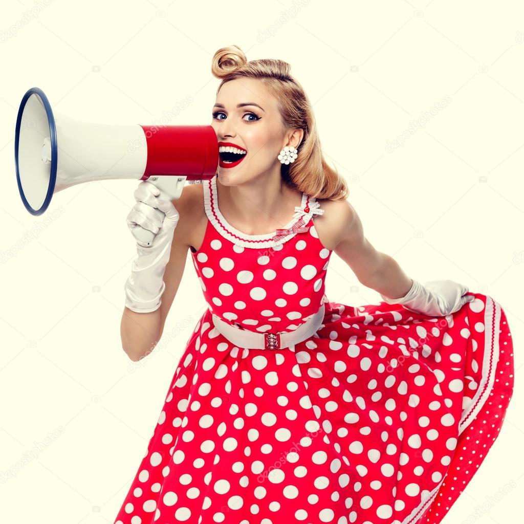 happy woman holding megaphone, dressed in pin-up style red dress