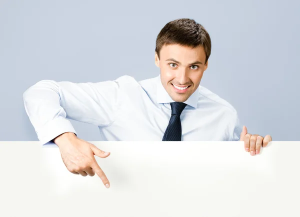 Business man showing blank signboard, over grey — Stock Photo, Image