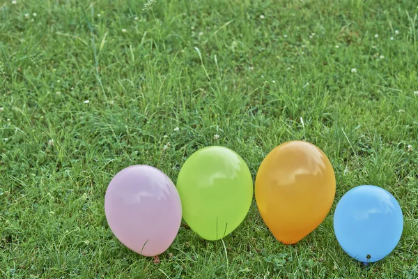 Balloons on the grass — Stock Photo, Image
