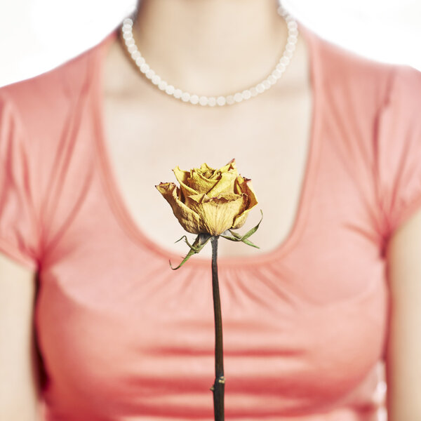 Yellow rose and decollete woman