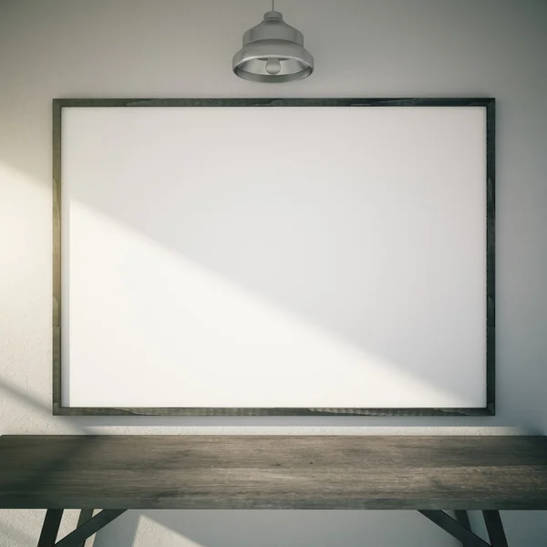 Blank picture frame with sunlight above wooden table and lamp, m — Stock Photo, Image
