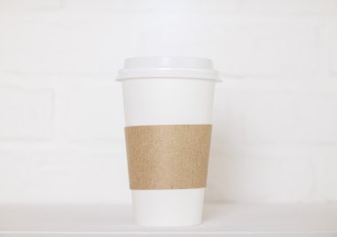 Coffee cup on white brick clipart