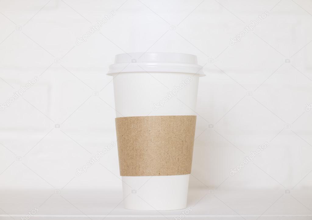 Coffee cup on white brick