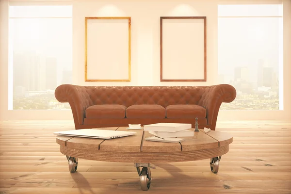 Table, sofa and two  frames — Stock Photo, Image