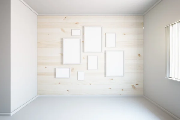 Light wooden wall with frames — Stock Photo, Image