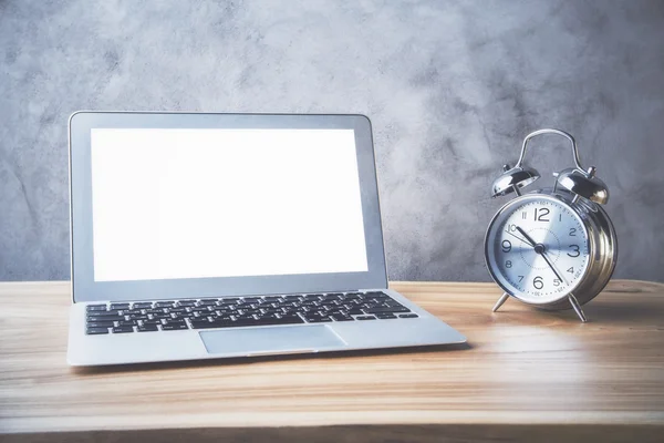 Table with laptop and alarm