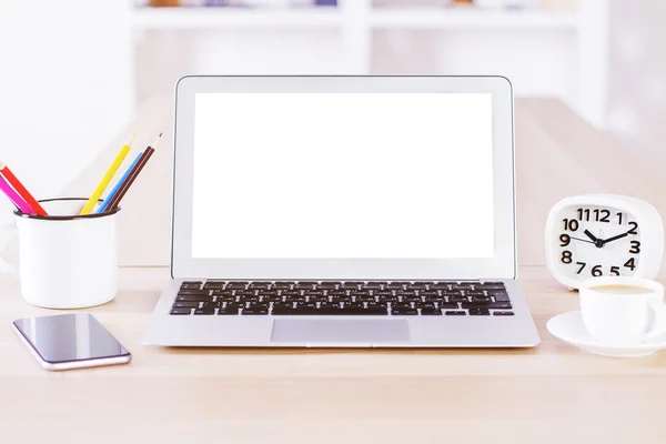 Blank white laptop screen on desktop with coffee, clock and phone. Mock up — Stock Photo, Image