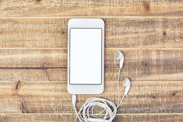 Λευκό smartphone με τα ακουστικά — Φωτογραφία Αρχείου